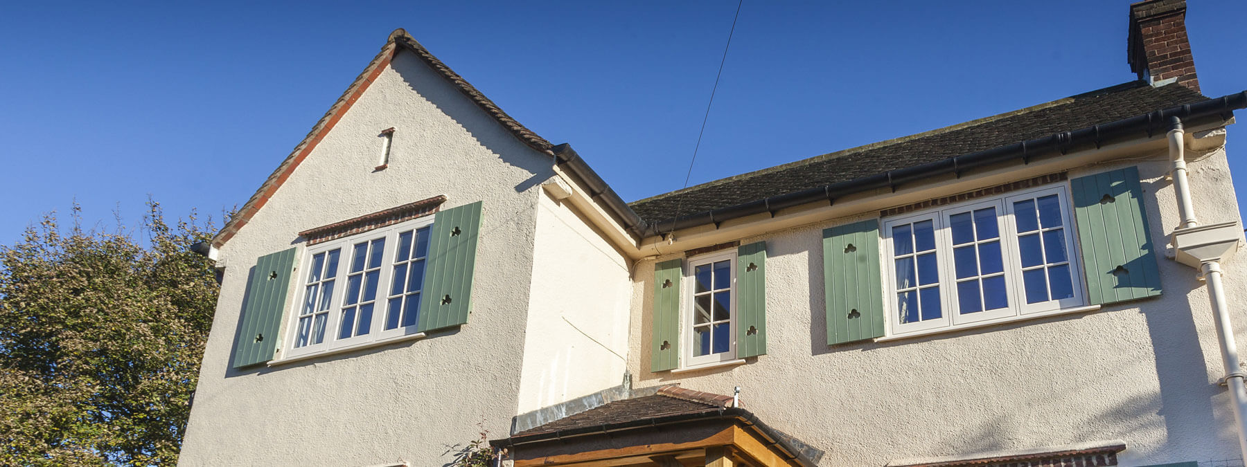 White-flush-sash-with-green-shutters White flush sash window with green shutters