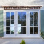 White uPVC flush sash window with shutters